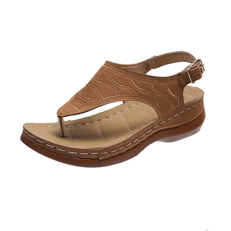 Women's black casual wedge heel flip flop sandals showing adjustable back buckle strap and solid colour design.