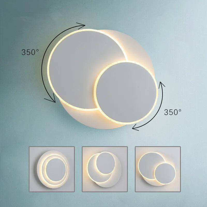 Modern round acrylic wall lamp in black or white, shown in 14cm, 18cm and 22cm diameter sizes.