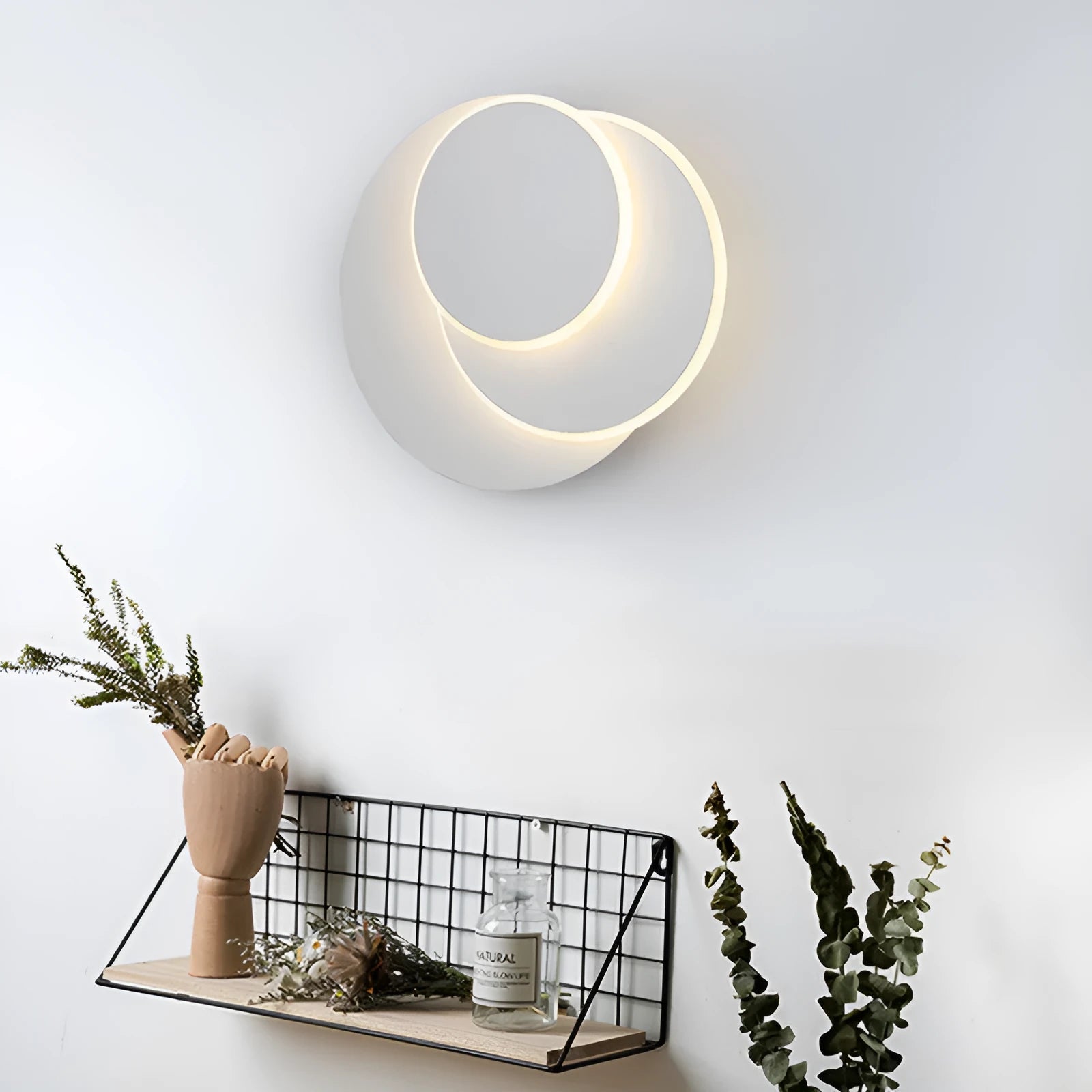 Modern round acrylic wall lamp in black or white, shown in 14cm, 18cm and 22cm diameter sizes.