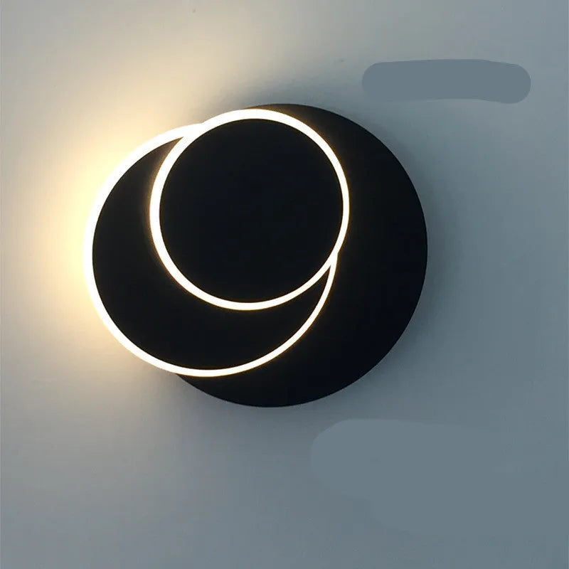 Modern round acrylic wall lamp in black or white, shown in 14cm, 18cm and 22cm diameter sizes.