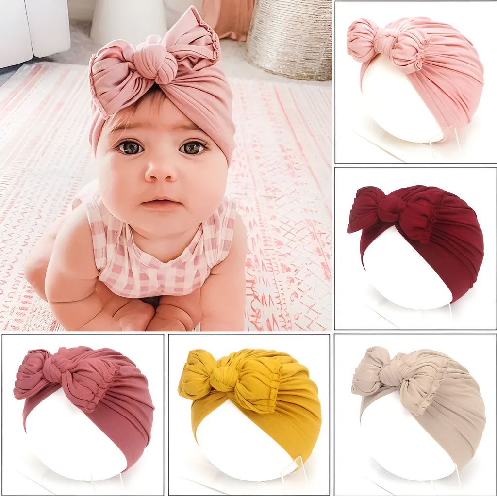 Soft acrylic knitted baby hat in a solid colour, shown stretched to demonstrate fit.
