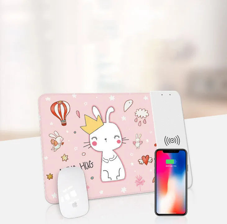 Black wireless charging mouse pad with cartoon design, RGB edge lighting, and non-slip rubber base.