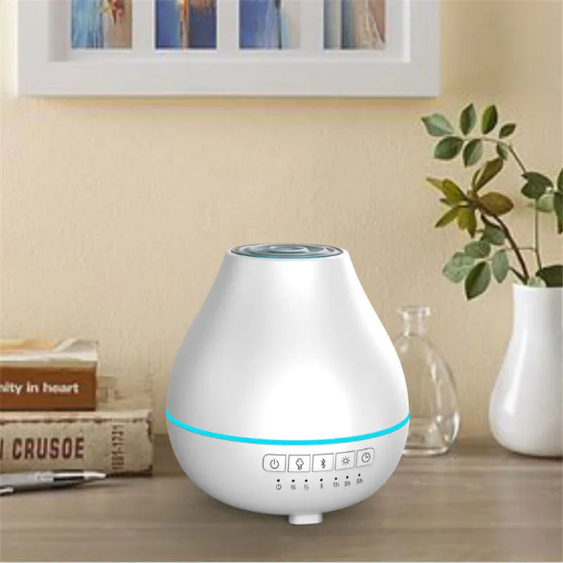 White circular Bluetooth humidifier and aroma diffuser with single mist outlet on a table