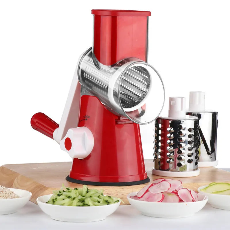 Blue multi-function vegetable chopper with slicer, grater and suction cup base on a kitchen counter.