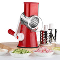 Blue multi-function vegetable chopper with slicer, grater and suction cup base on a kitchen counter.