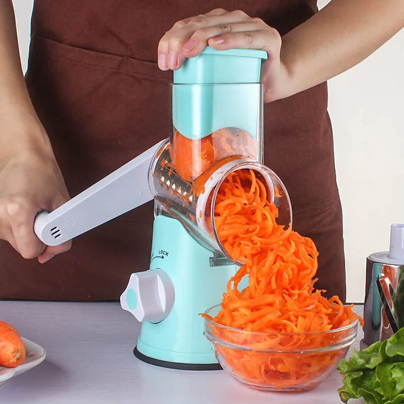 Blue multi-function vegetable chopper with slicer, grater and suction cup base on a kitchen counter.