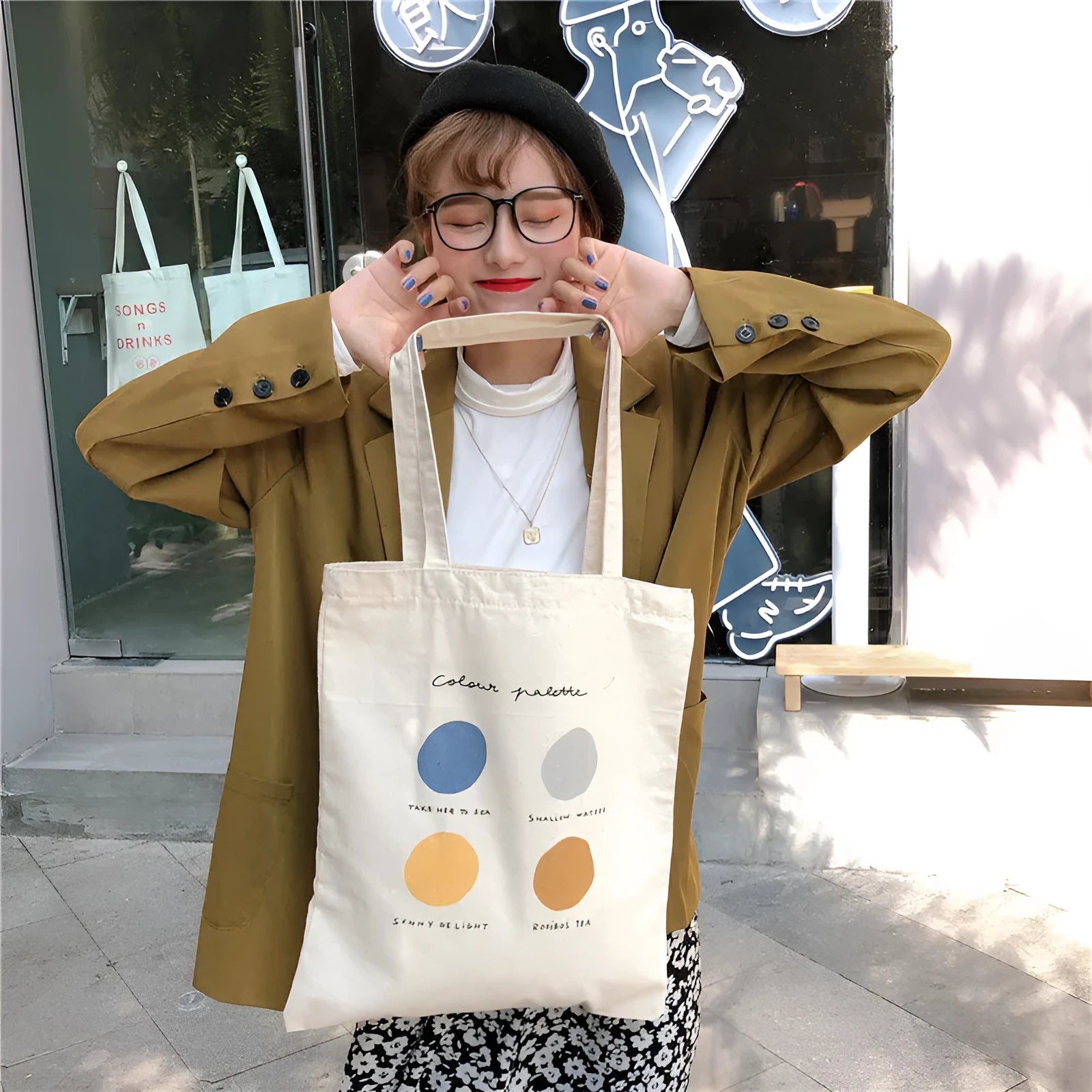 Women's orange geometric print canvas tote bag with zipper closure and shoulder straps.