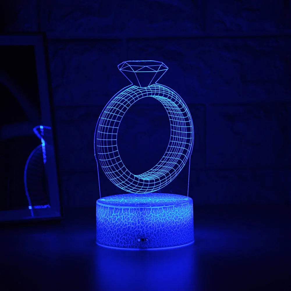 3D LED night light projecting illuminated diamond ring image with colour-changing glow.