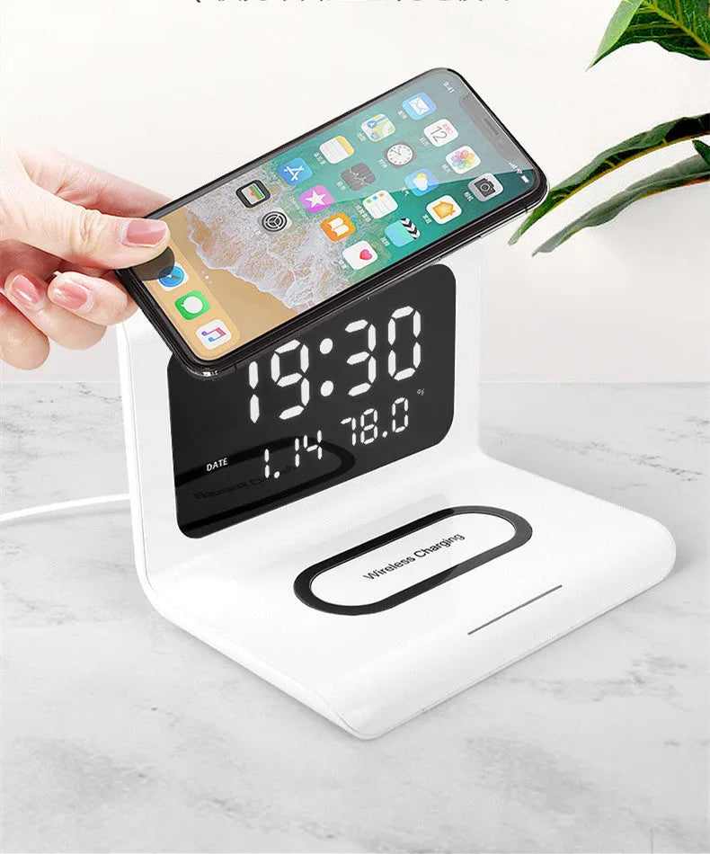 White wireless charger alarm clock showing time, date, temperature and humidity with charging surface