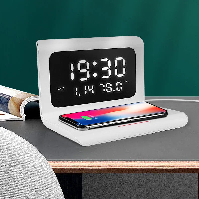 White wireless charger alarm clock showing time, date, temperature and humidity with charging surface