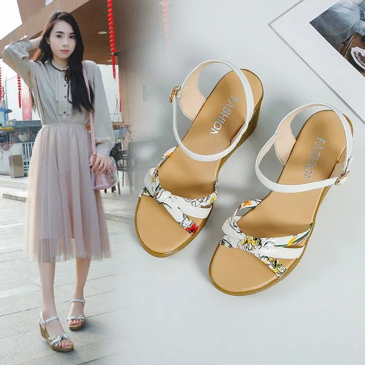 Women's pink wedge sandals with a fish mouth open toe and a buckle strap on a non-slip sole.