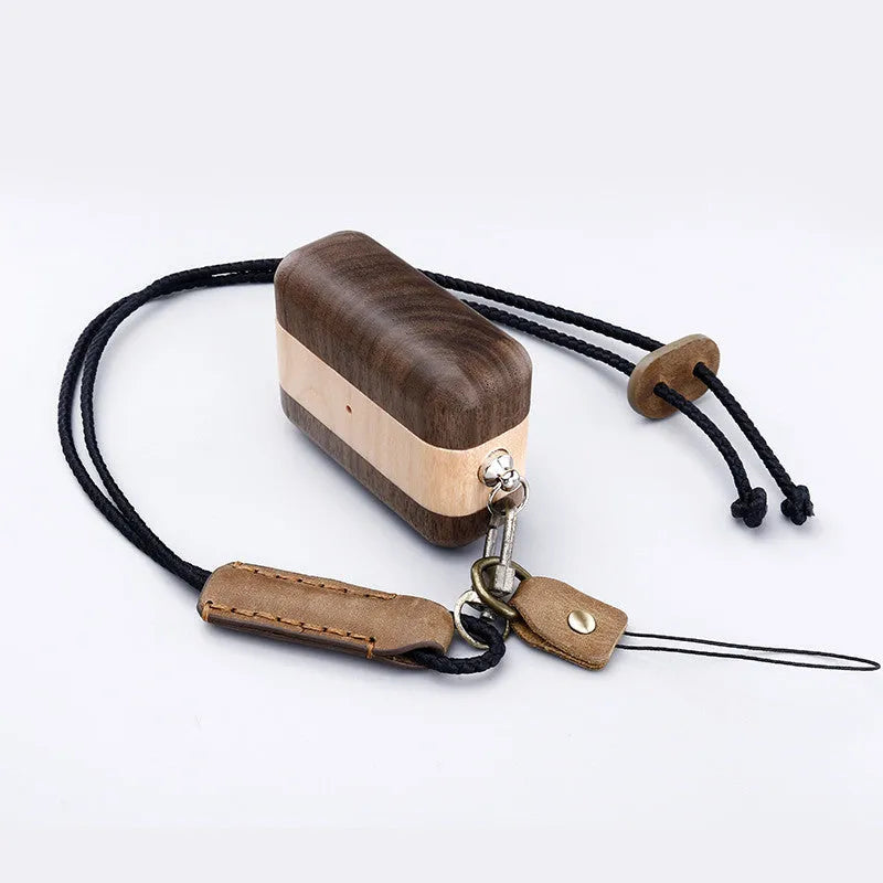 Solid wood Bluetooth earphone sleeve in a choice of natural wood finishes next to wireless earphones
