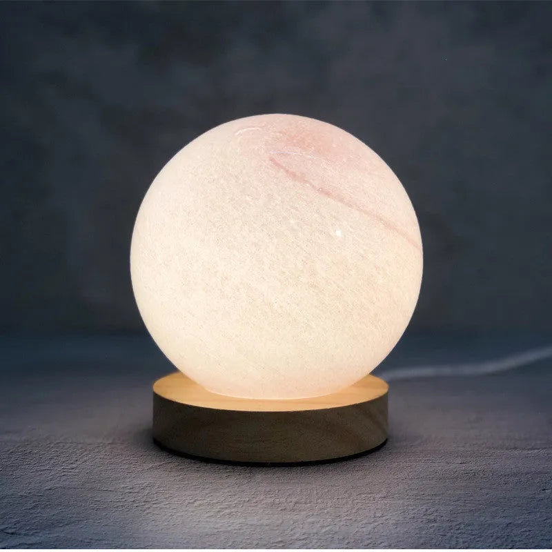 Nordic style USB table lamp with glass shade in amber colour on bedside table