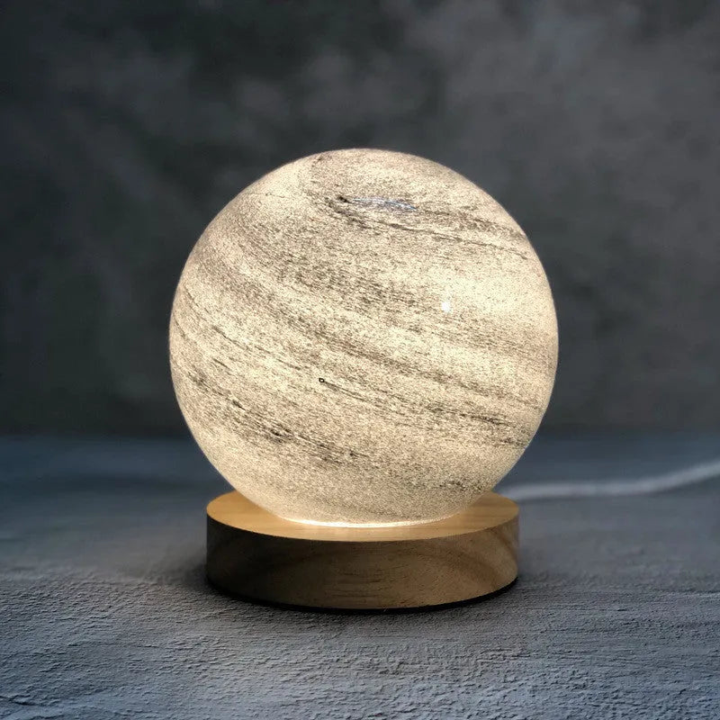 Nordic style USB table lamp with glass shade in amber colour on bedside table