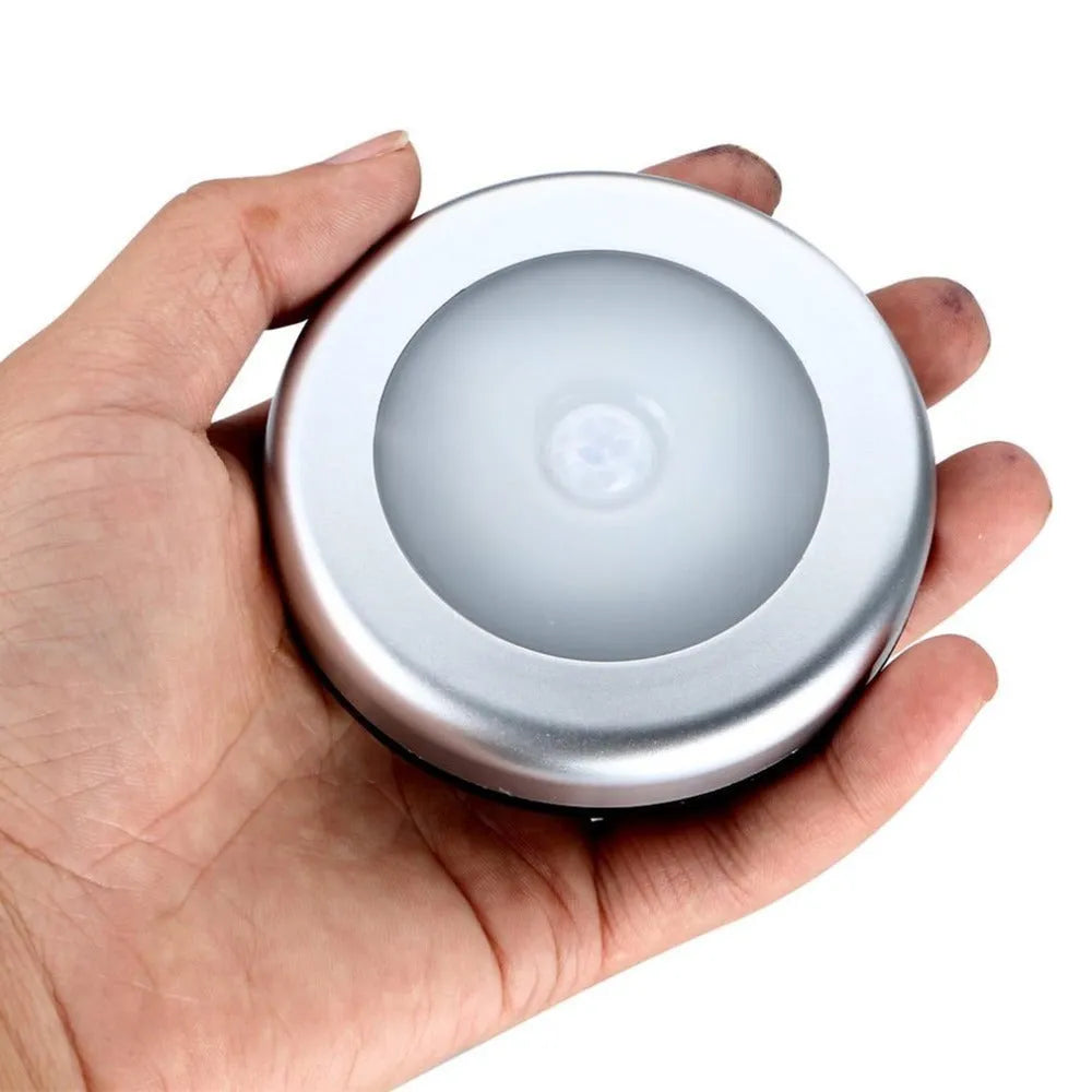 Silver circular wireless motion sensor night light unit showing 80mm diameter size