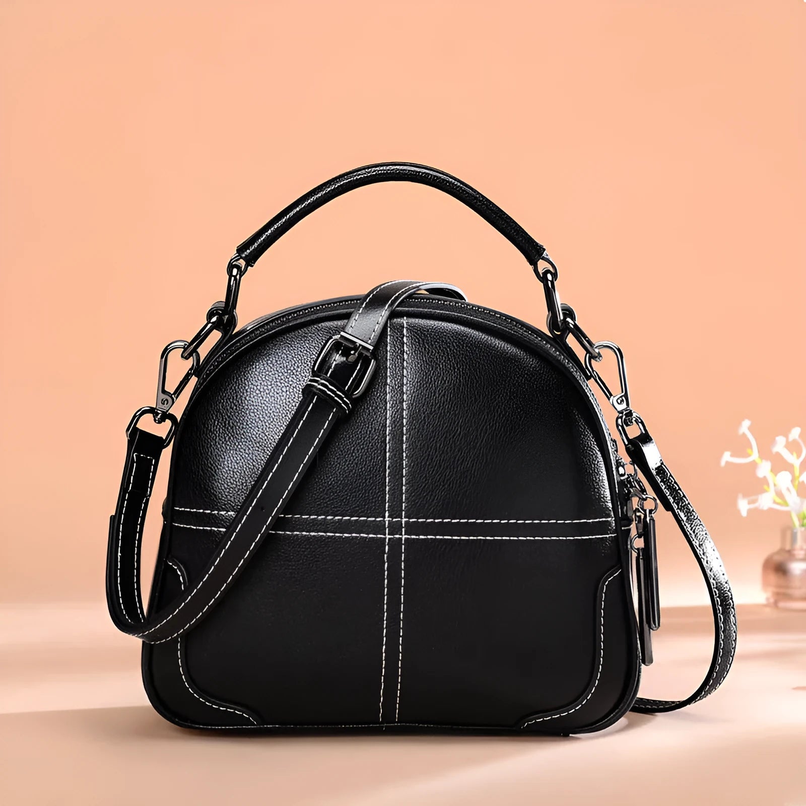 Simple round leather women's handbag with soft double handles and a zipper opening