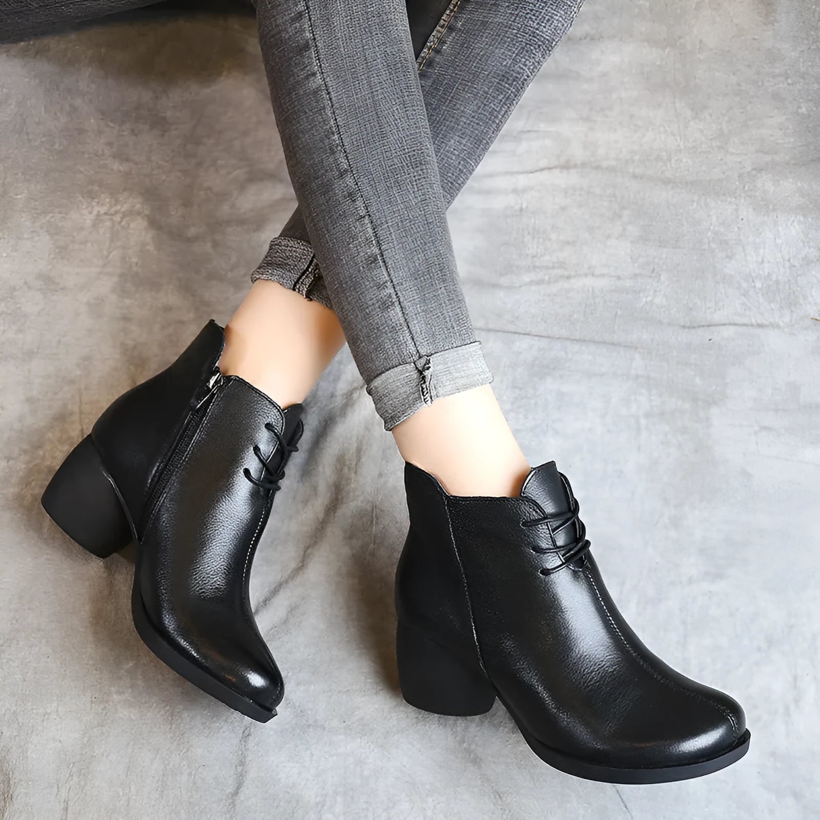 Women's black leather Martin boots with a thick, round heel and vintage styling.