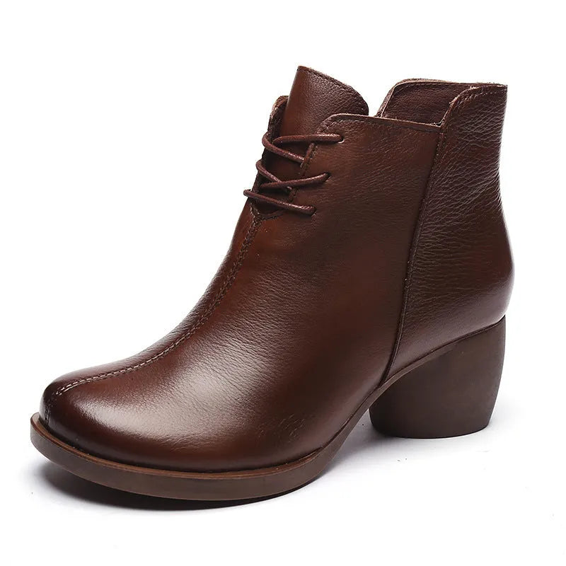 Women's black leather Martin boots with a thick, round heel and vintage styling.