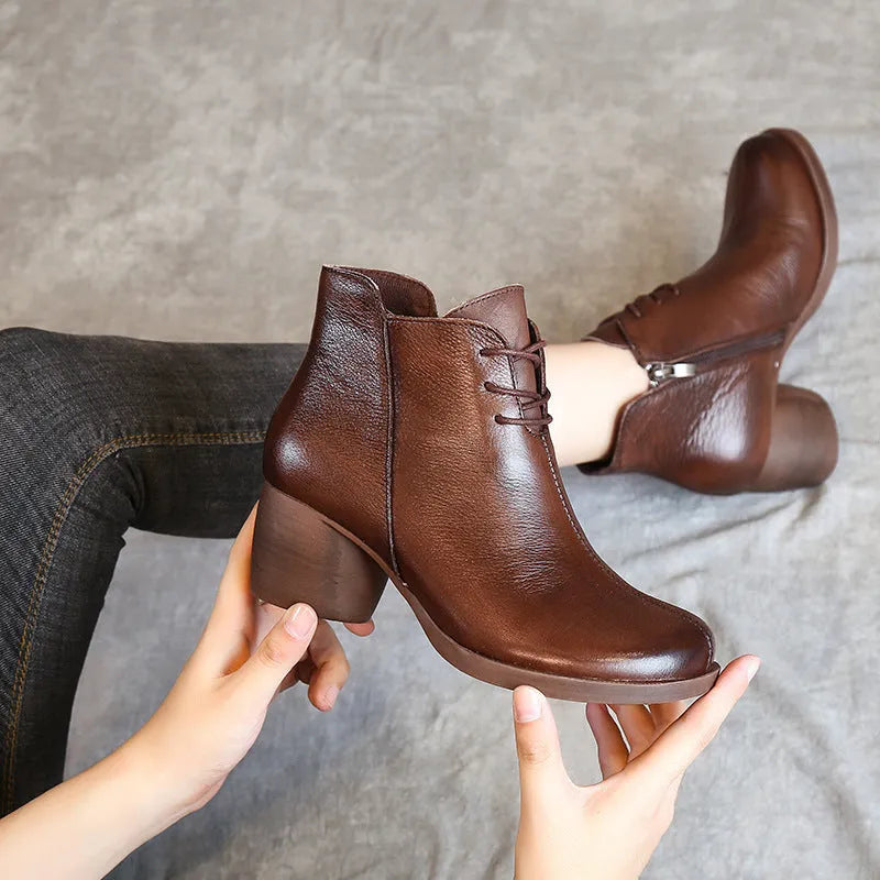 Women's black leather Martin boots with a thick, round heel and vintage styling.