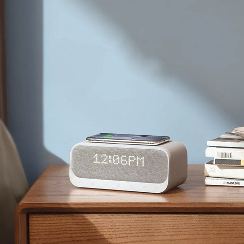 White Anker Soundcore Bluetooth speaker with integrated display and wireless charging surface.