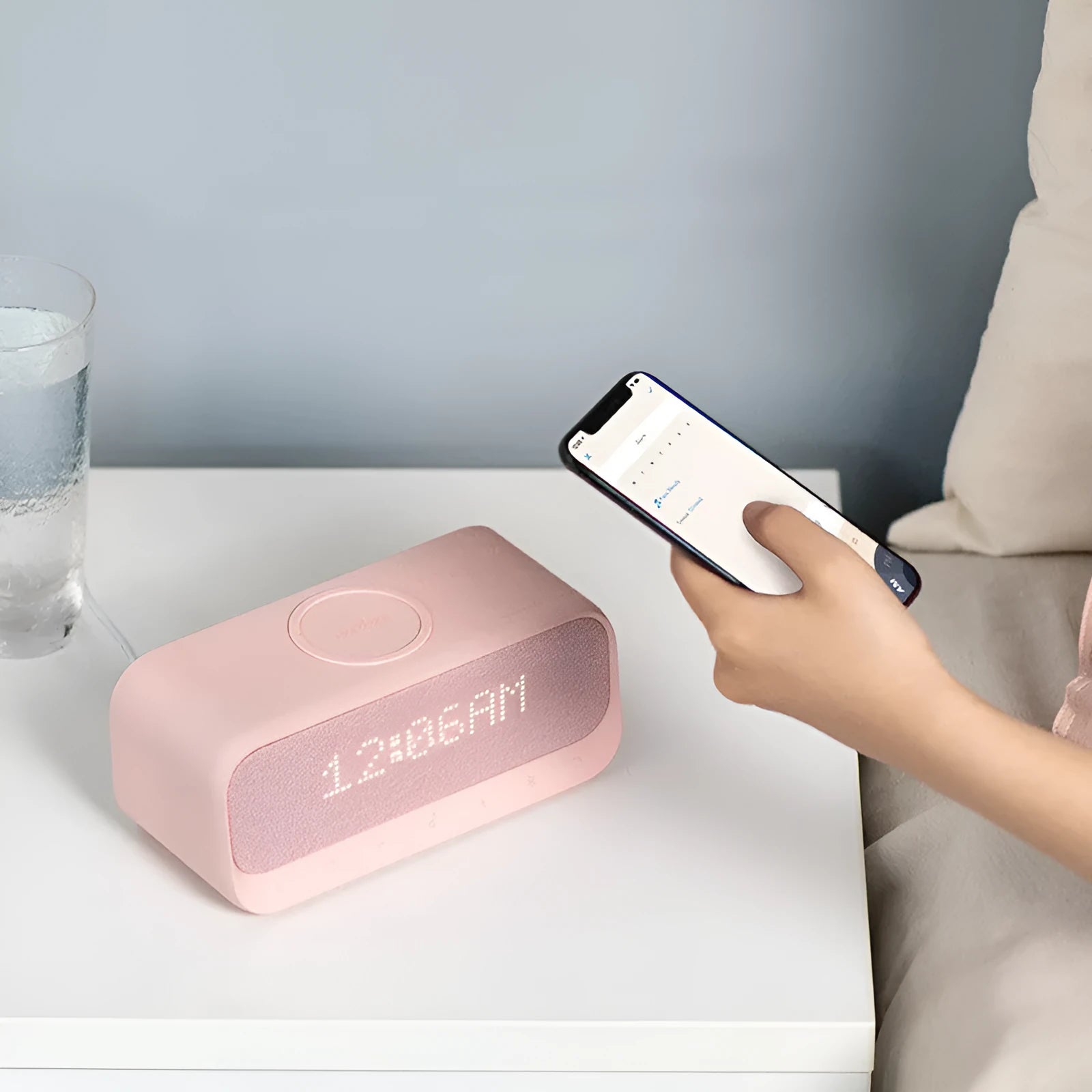 White Anker Soundcore Bluetooth speaker with integrated display and wireless charging surface.