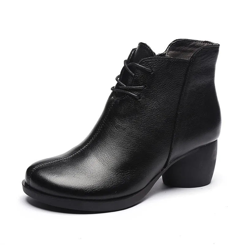 Women's black leather Martin boots with a thick, round heel and vintage styling.