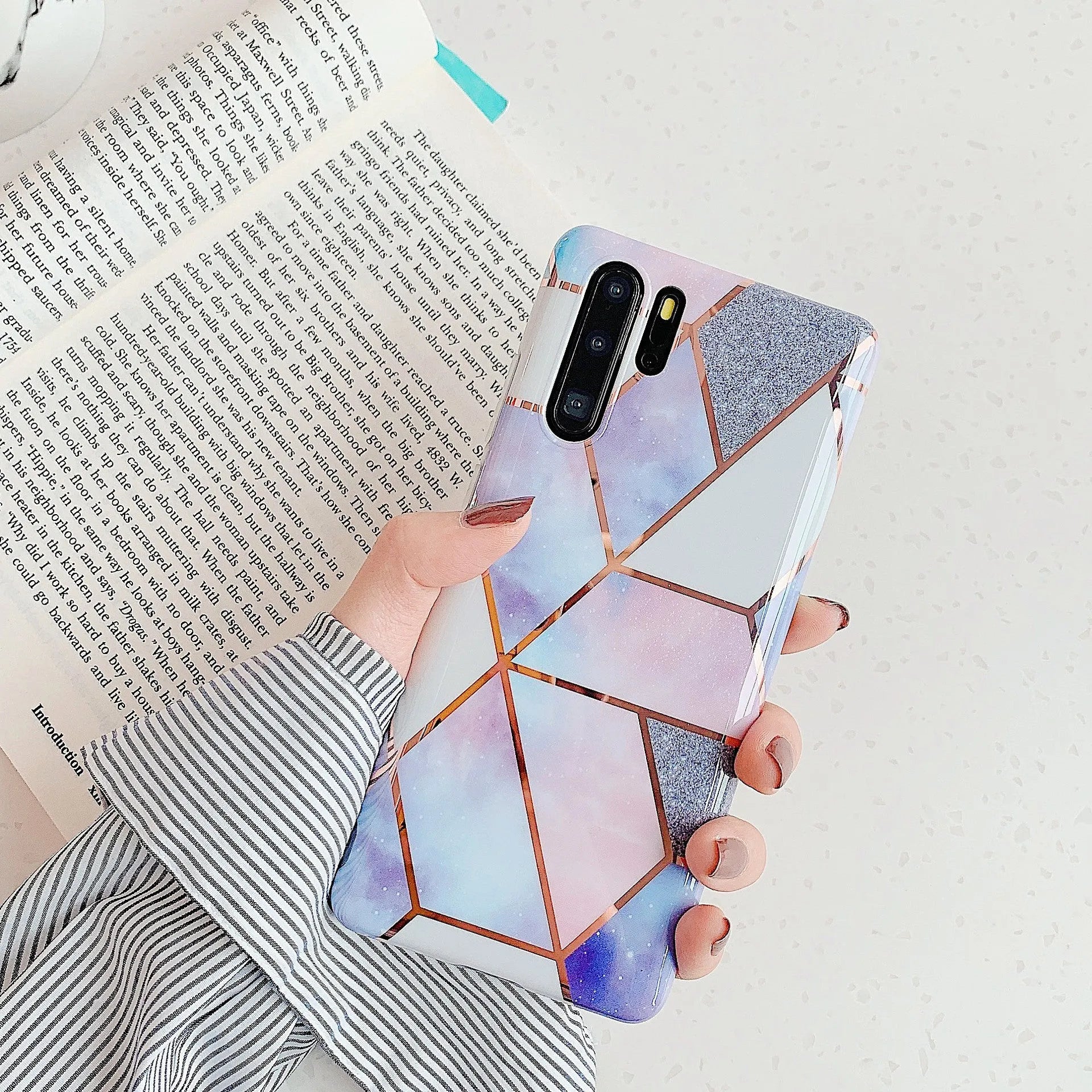 Glossy electroplated marble design TPU back cover case for a Huawei smartphone.