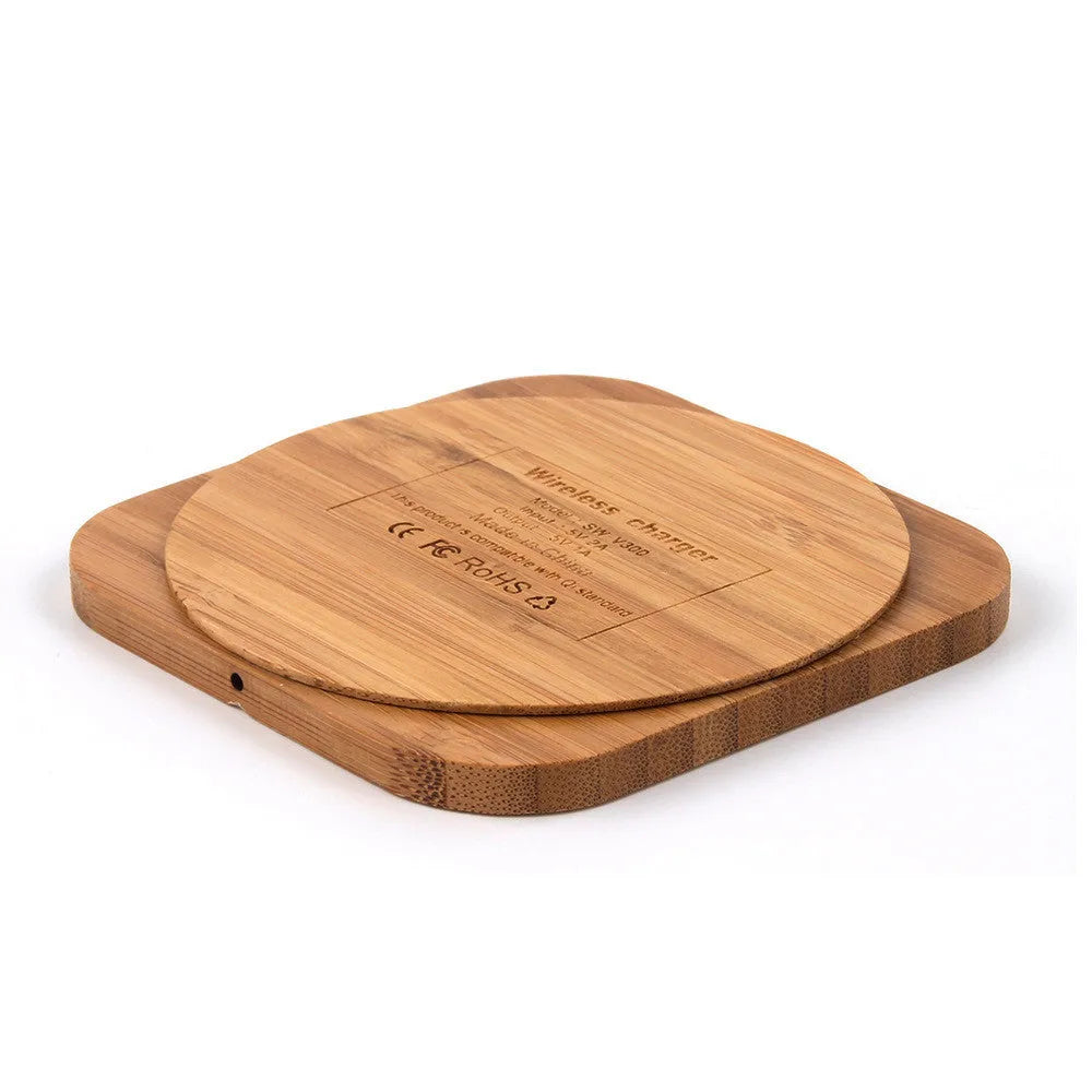 Square wooden bamboo 5W Qi wireless charging pad on a desk.