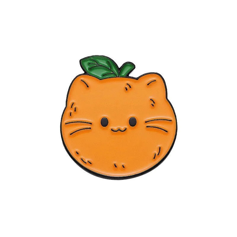 Colourful cartoon fruit design metal brooch pin on a fabric background.