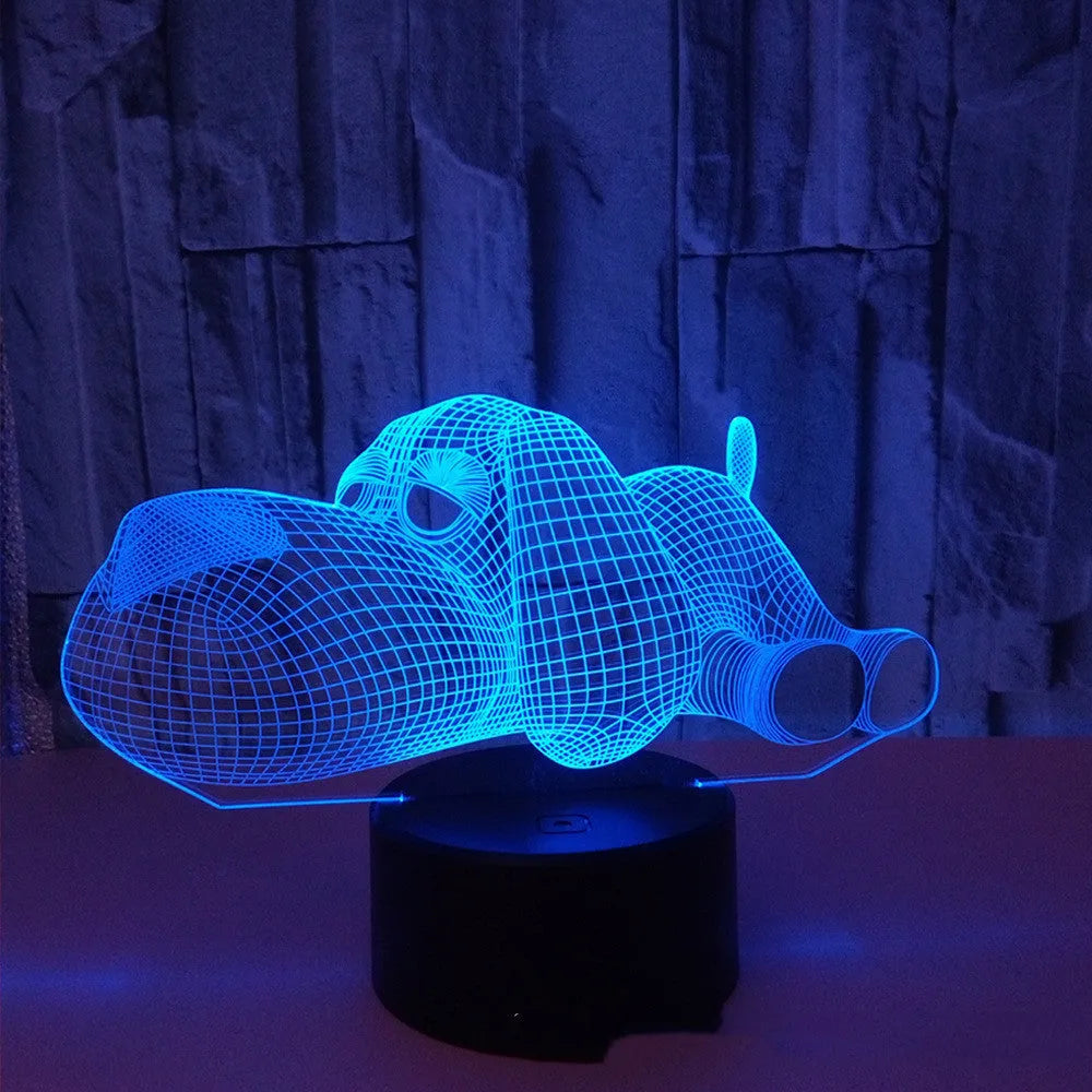 Dog-shaped 3D desktop lamp glowing in multiple colours on a wooden surface.