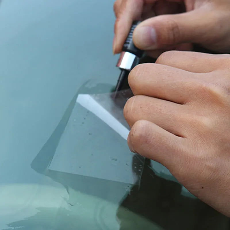 Yellow three-piece car windshield repair agent tool set with applicator and curing tools.