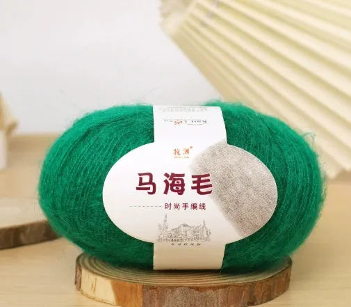 DIY mohair scarf weaving kit showing one wool ball and a selection of 34 colour options including white, pink, blue and green.