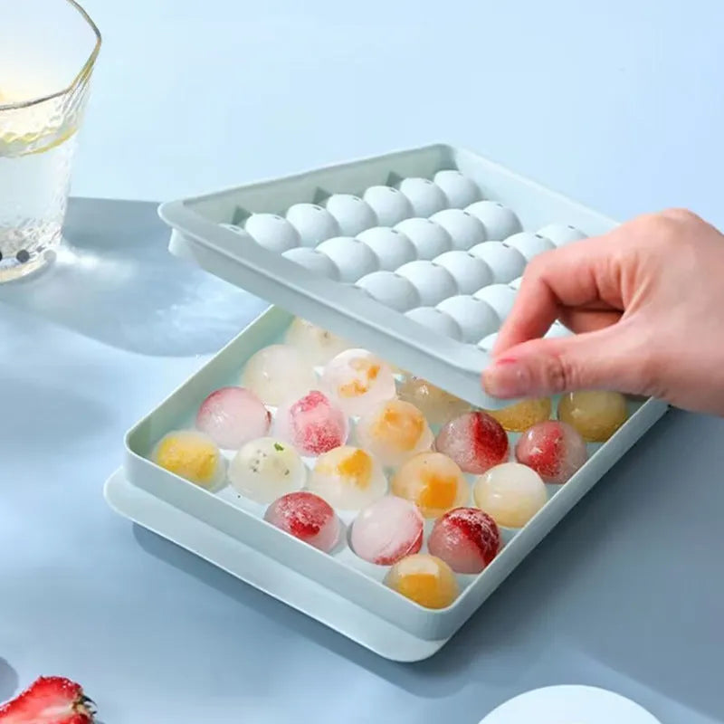 Blue silicone ice cube tray with lid showing 33 round moulds