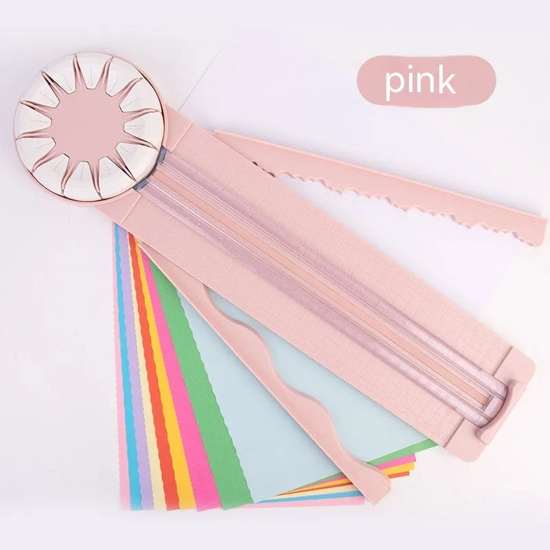 Plastic 12-in-1 paper cutter machine with dotted guide lines in pink colour on white background