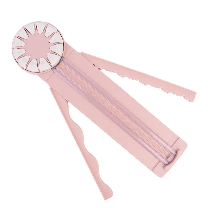 Plastic 12-in-1 paper cutter machine with dotted guide lines in pink colour on white background