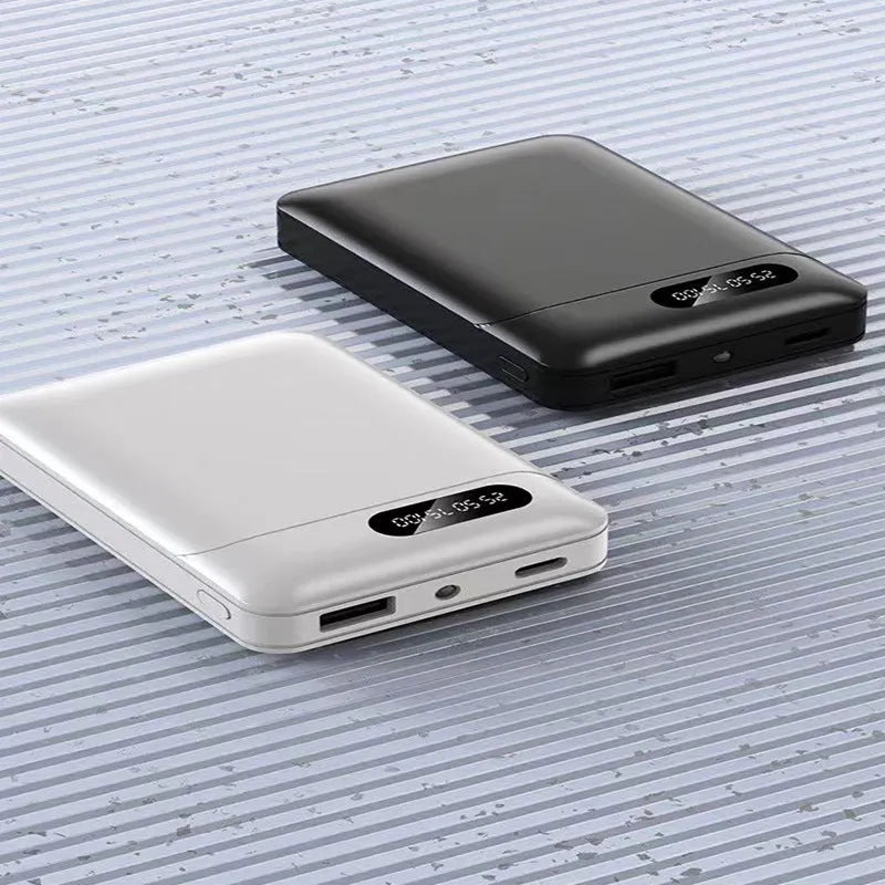 White or black portable power bank with multiple USB ports showing compact 92x63x23mm dimensions