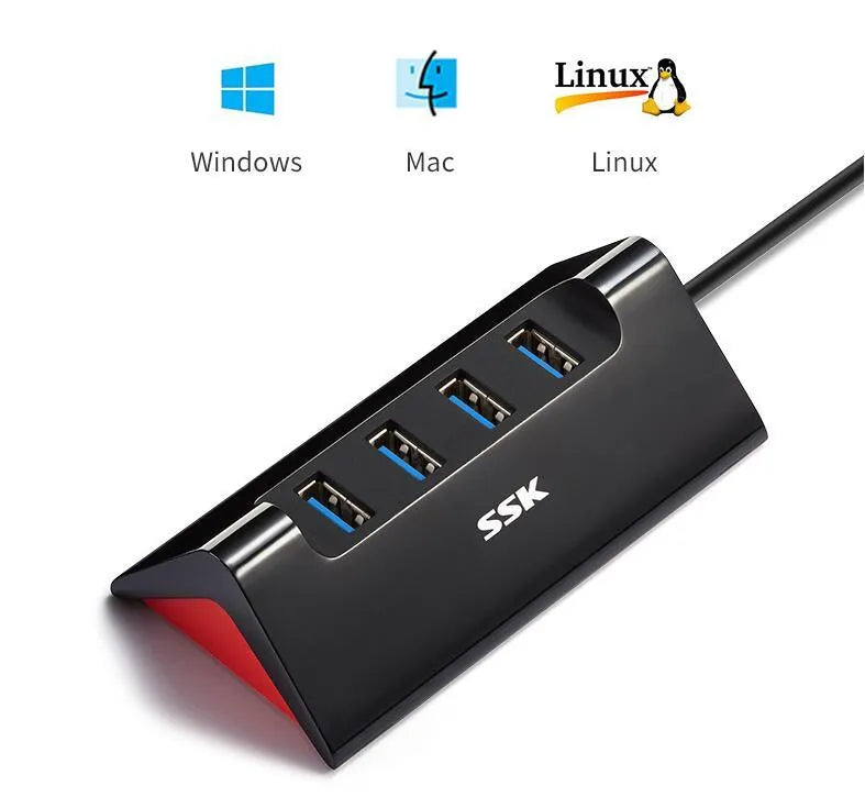 Black USB expansion dock with 4 ports on a desk next to a laptop.