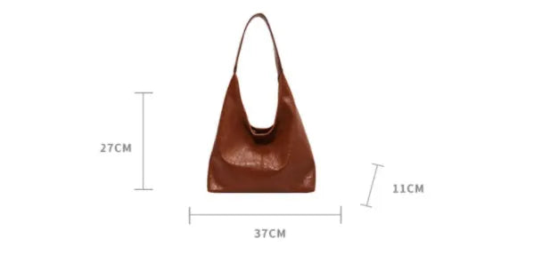 Soft leather shoulder bag in black with sandwich pocket design and shoulder strap