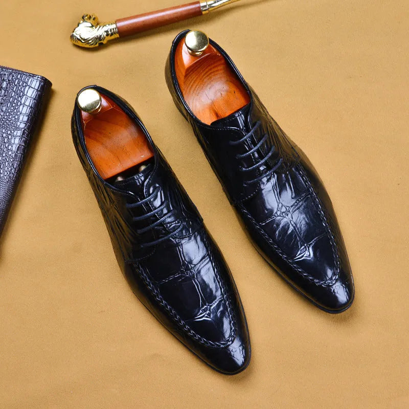 Men's brown leather loafers with a silver horse bit buckle on a rubber sole.