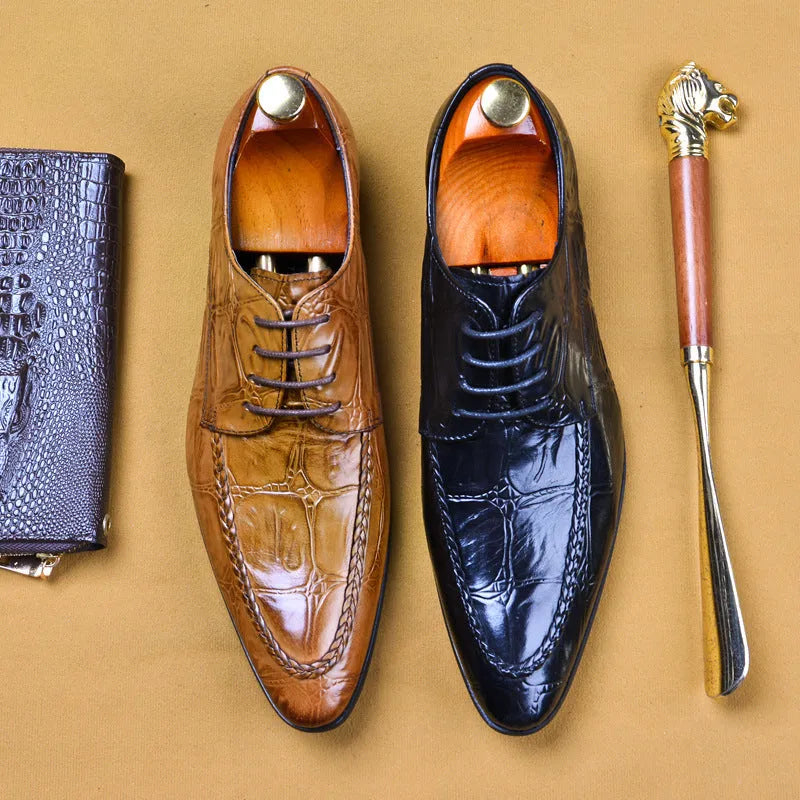 Men's brown leather loafers with a silver horse bit buckle on a rubber sole.