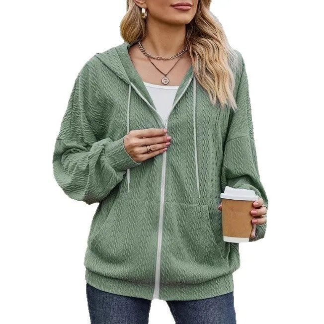 Green women's hooded zipper coat with long sleeves on a hanger