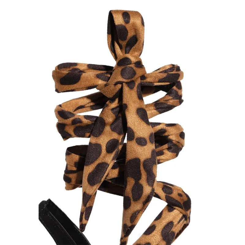 Light brown leopard print Roman style high heels with cross strap and thin 8cm heel.