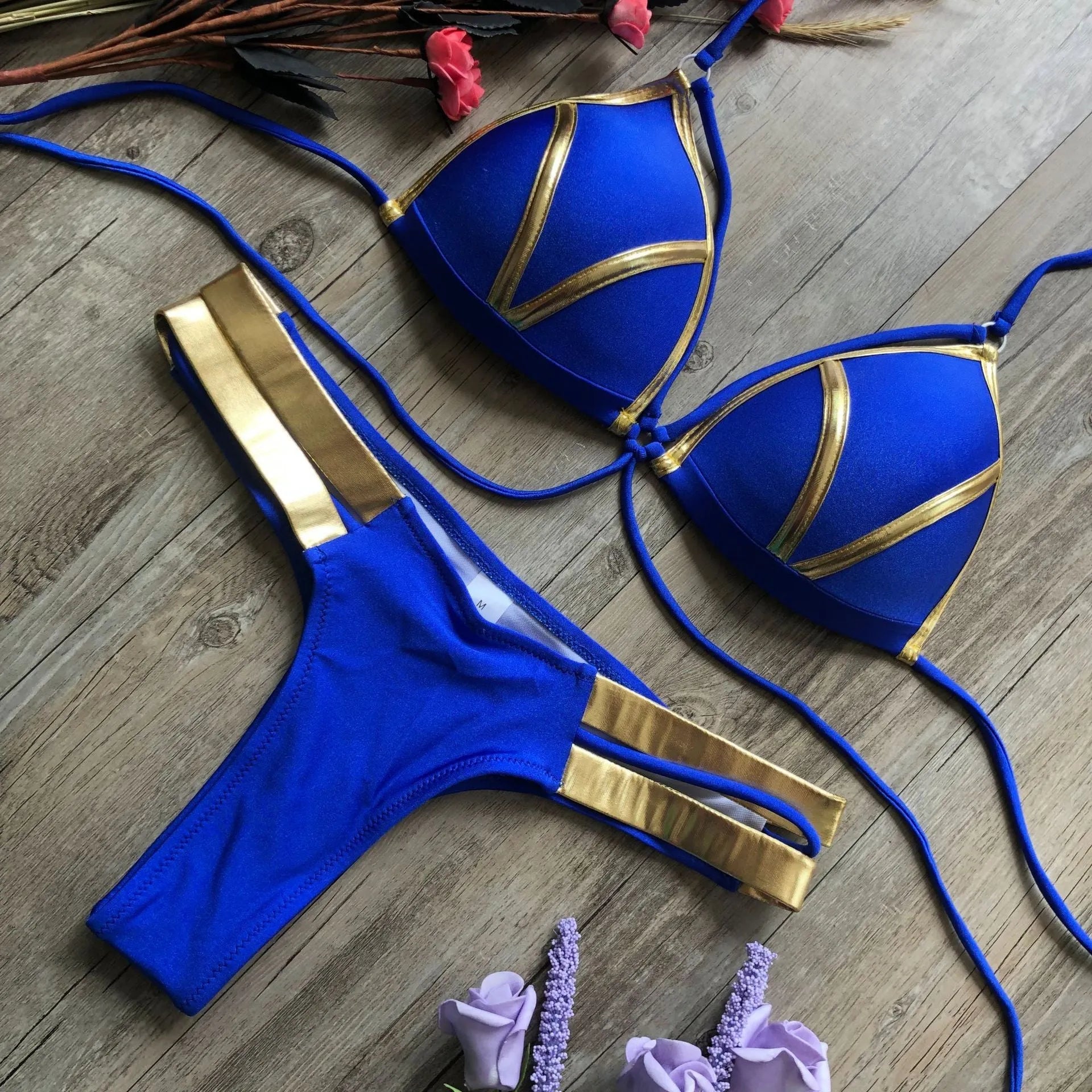 Women's bronzing bikini swimsuit with removable pads and cotton lining on a mannequin.