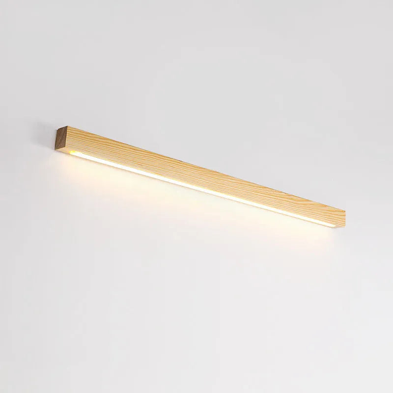 Walnut coloured log strip wall lamp with a square wood and acrylic profile mounted on a wall.