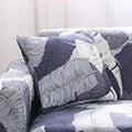 Printed stretch sofa cover with geometric pattern on three-seater sofa