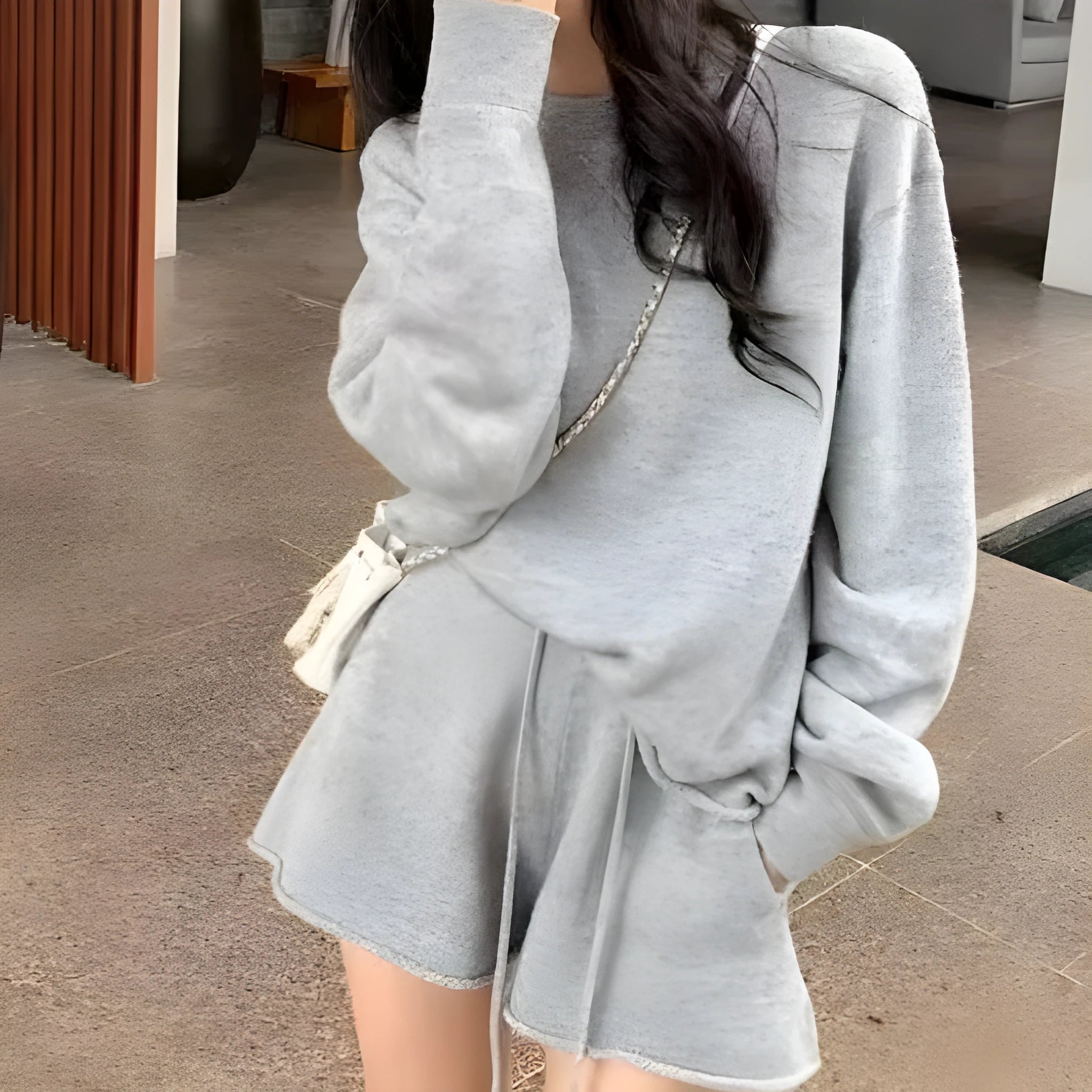 Women's loose grey knitted sweater and wide leg shorts two-piece loungewear set.