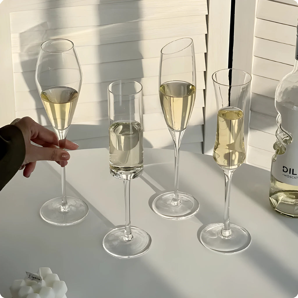 A single clear French goblet champagne glass on a table.