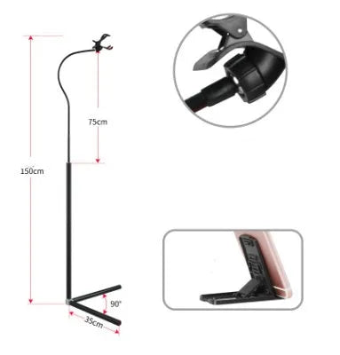 A black mobile phone bed bracket clipped to a bed frame, holding a smartphone in an overhead viewing position.