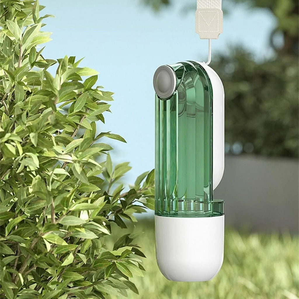 Beige foldable dog water bottle and food dispenser with tray, shown next to a dog on a walk.