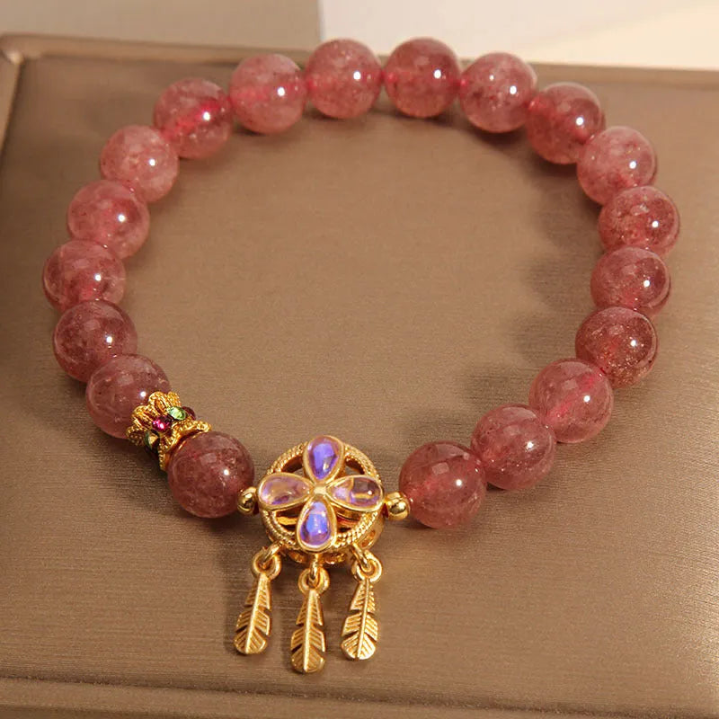 Women's strawberry quartz bracelet with four leaf clover dream catcher ball pendant